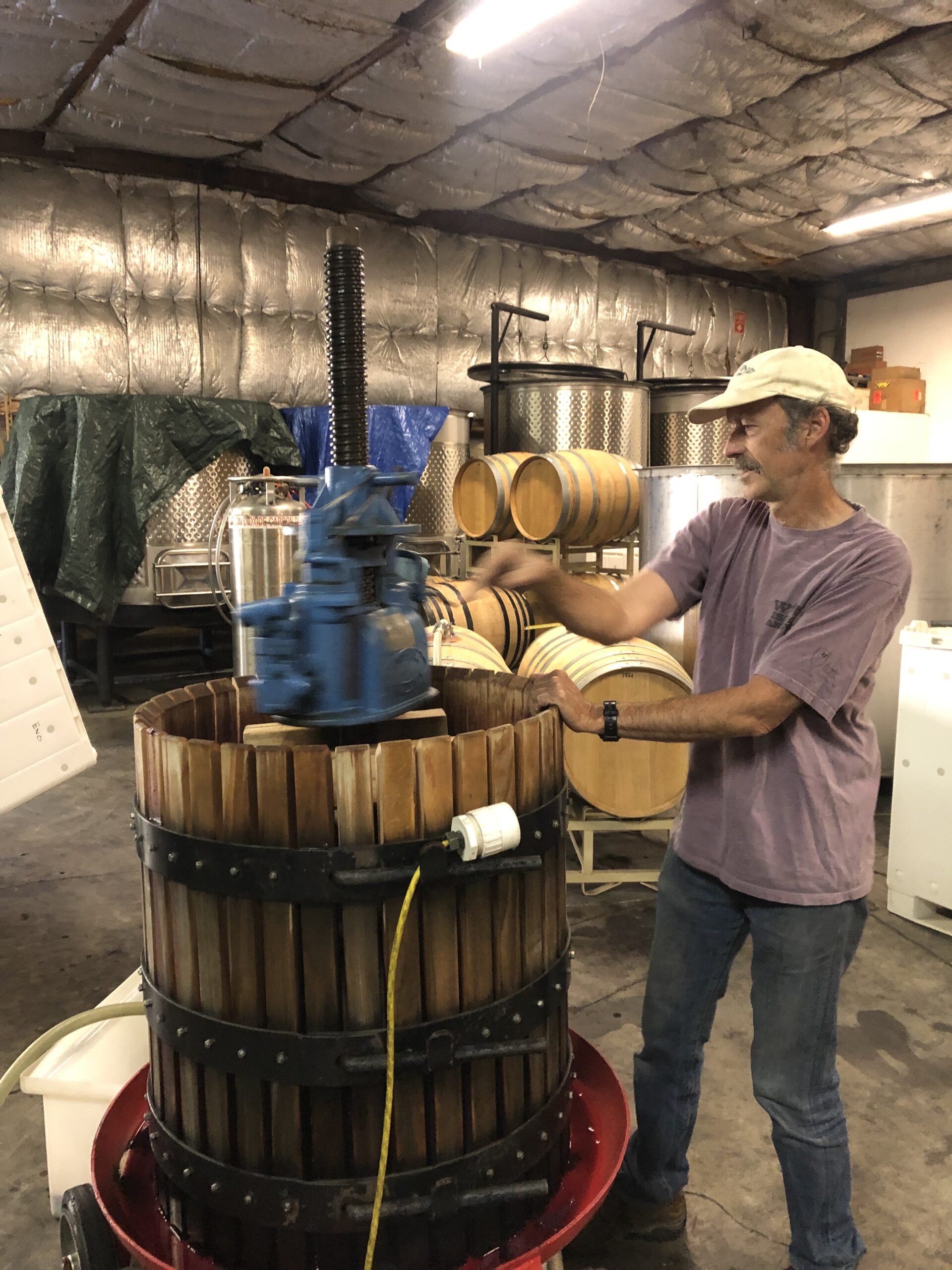 Fred Scherrer running the small manual press